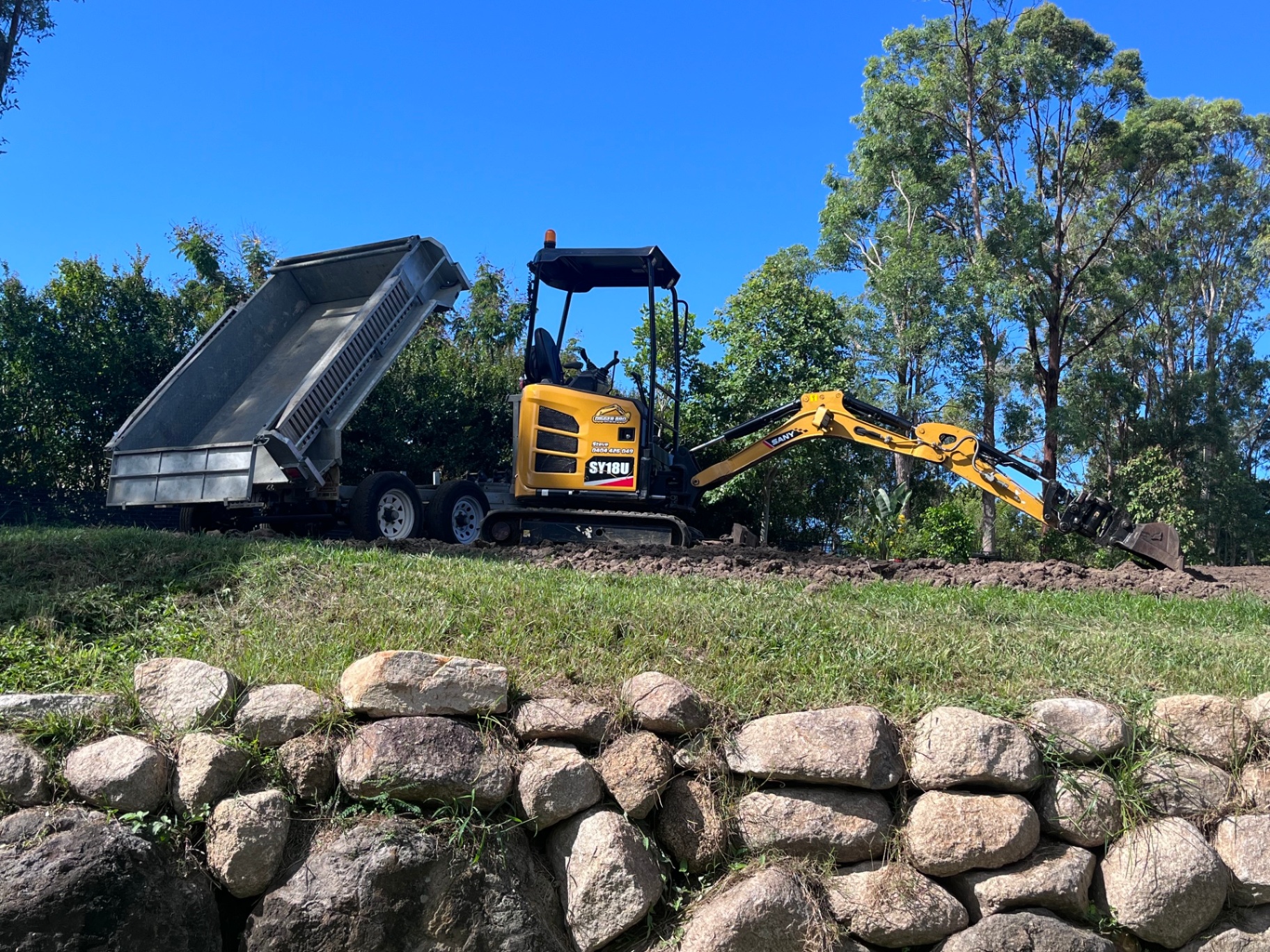 Digger Bro mini excavator working a site cut
